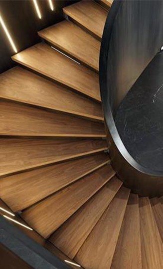 Sculptural stair — timber treads & stone core