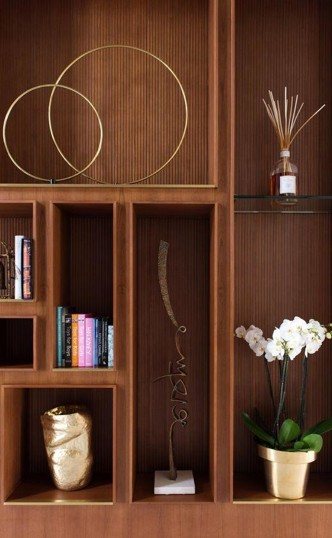Shelving detail — brass rings & curated objects
